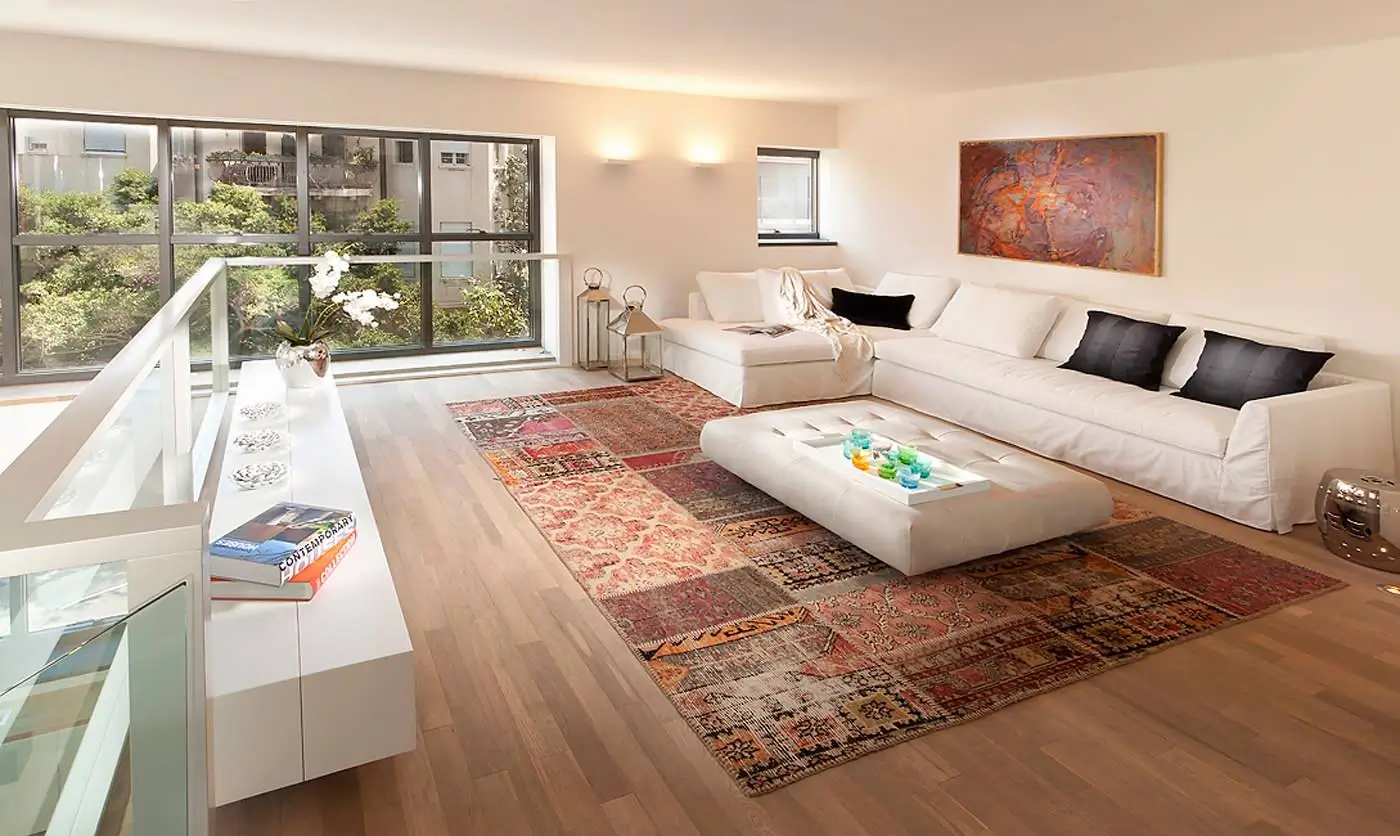 A beautifully crafted rug in a modern living room setting.