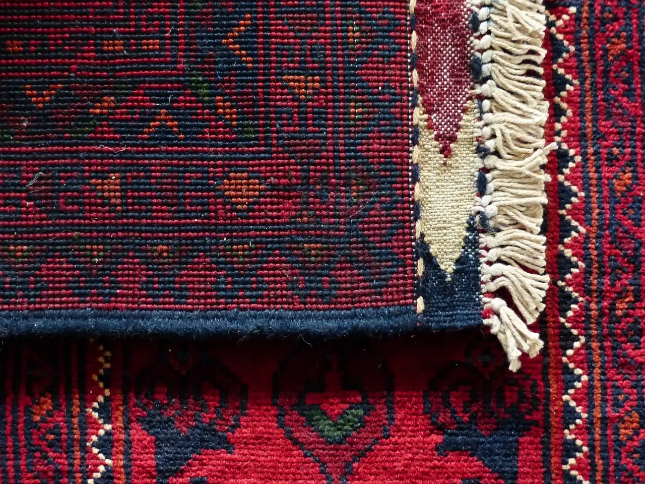 Detailed shot of a hand-woven carpet edge, showing craftsmanship.